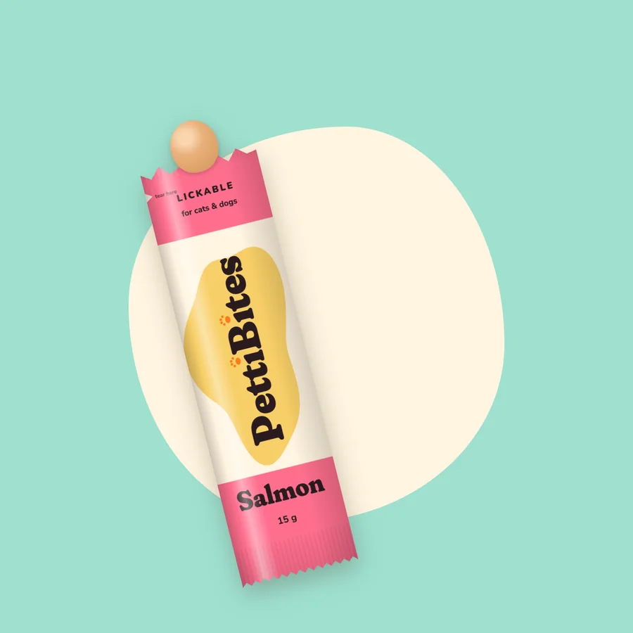 A torn-open PettiBites Salmon stick with paste at the tip